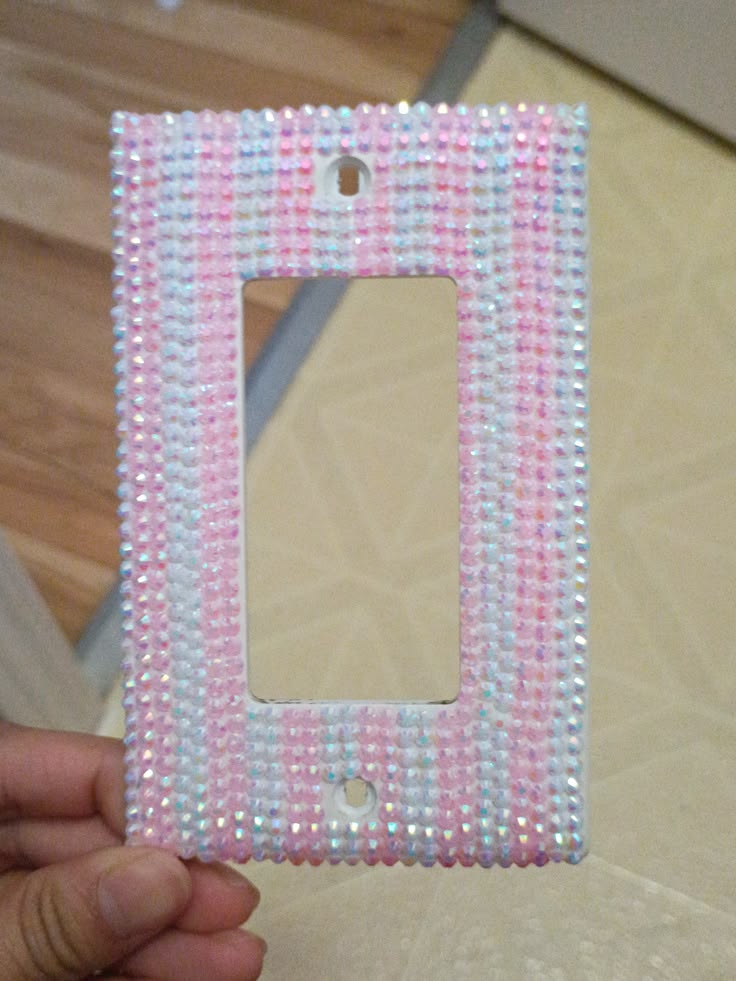 Dry-laying a rhinestone pattern on a switch plate before gluing
