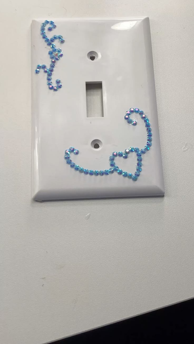 Minimalist light switch plate with a single line of metallic gems