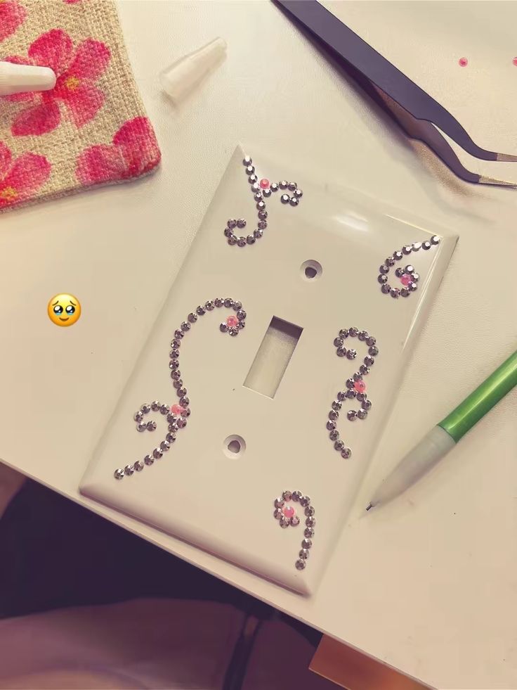 Bedazzled switch plate placed near a bedroom vanity mirror for matching sparkle